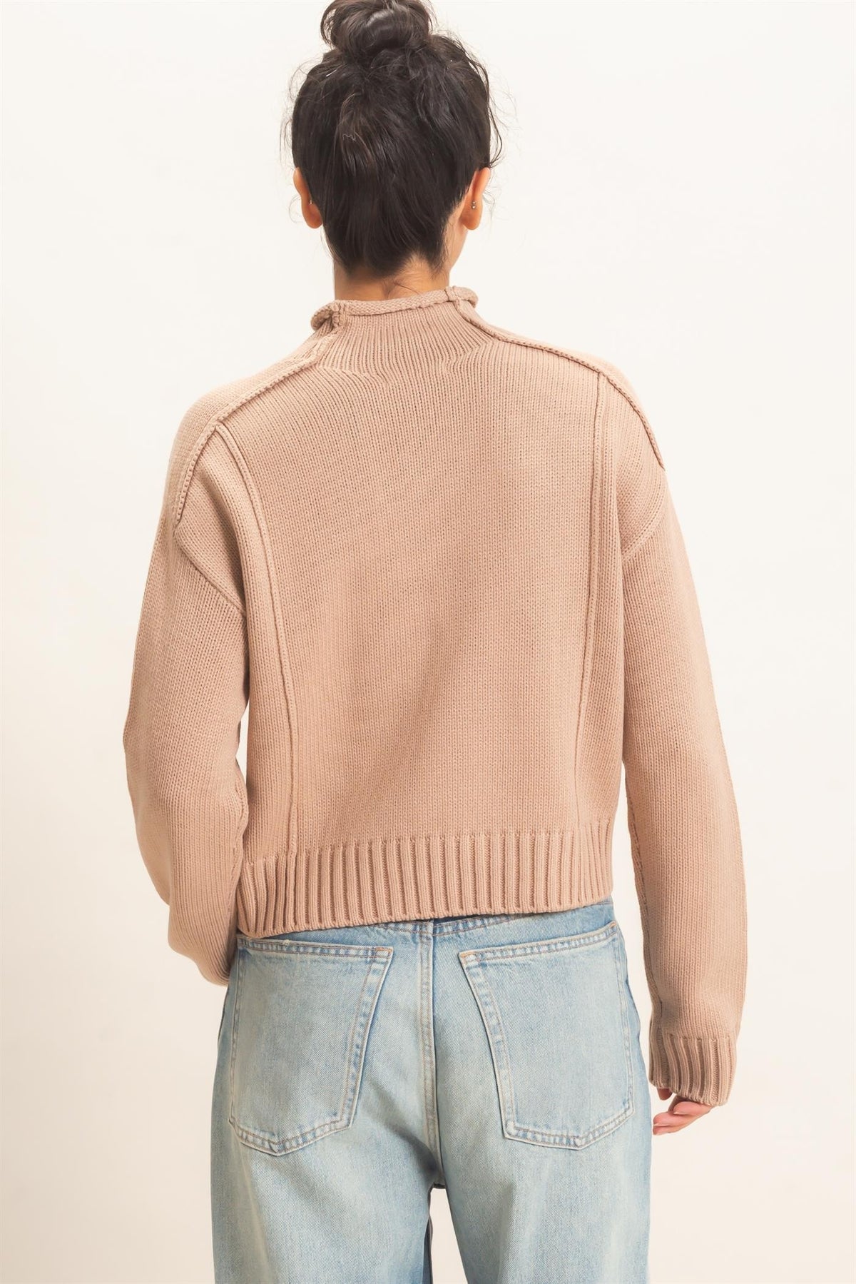 Remy Roll Neck Reversed Seam Sweater in Taupe — side view showing roll neck and relaxed silhouette