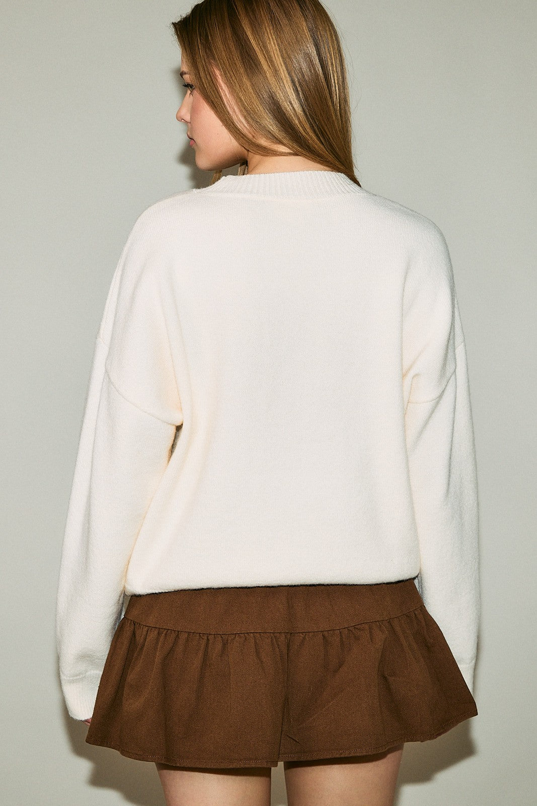 Cockapoo Graphic Oversized Crew Neck Sweater in Ivory — side view showing drop-shoulder oversized fit