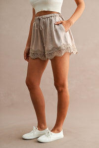 Satin Lace Trim Drawstring Shorts in Taupe — close-up of floral lace hem trim detail