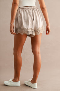 Satin Lace Trim Drawstring Shorts in Taupe — side view showing floral lace trim hem and drawstring waist