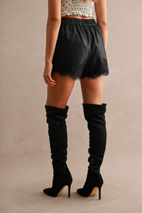 Faux Leather Lace Trim High-Waist Shorts in Black — side view showing high-waisted fit and lace trim hem
