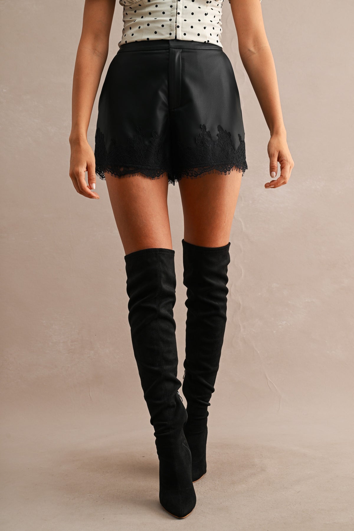 Faux Leather Lace Trim High-Waist Shorts in Black — front view on model