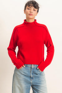 Remy Roll Neck Reversed Seam Sweater in Red — front view on model
