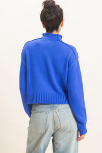 Remy Roll Neck Reversed Seam Sweater in Blue — close-up of reversed seam detail and ribbed neckline