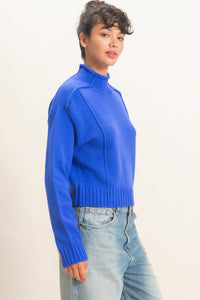 Remy Roll Neck Reversed Seam Sweater in Blue — side view showing roll neck and relaxed silhouette