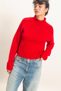 Remy Roll Neck Reversed Seam Sweater in Red — back view on model showing reversed seam detailing