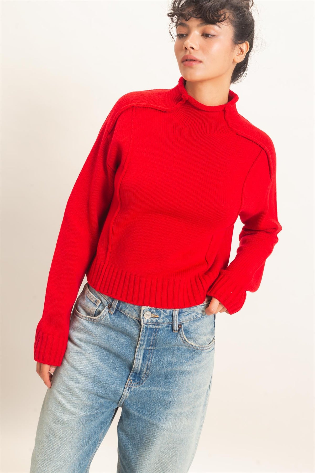 Remy Roll Neck Reversed Seam Sweater in Red — back view on model showing reversed seam detailing