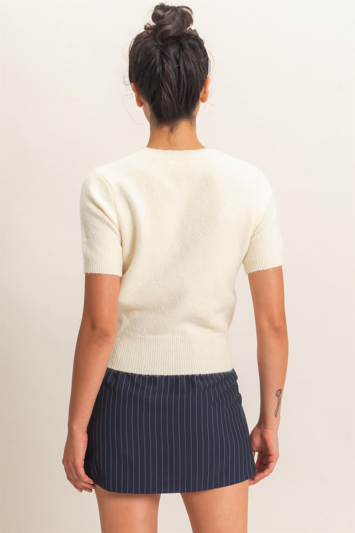 Wren Crew Neck Short Sleeve Knit Top in Cream — back view on model