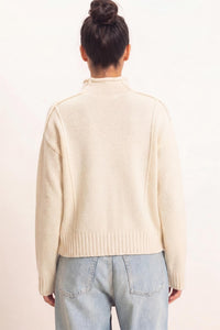 Remy Roll Neck Reversed Seam Sweater in Cream — side view showing roll neck and relaxed silhouette