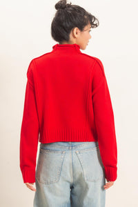Remy Roll Neck Reversed Seam Sweater in Red — close-up of reversed seam detail and ribbed cuffs
