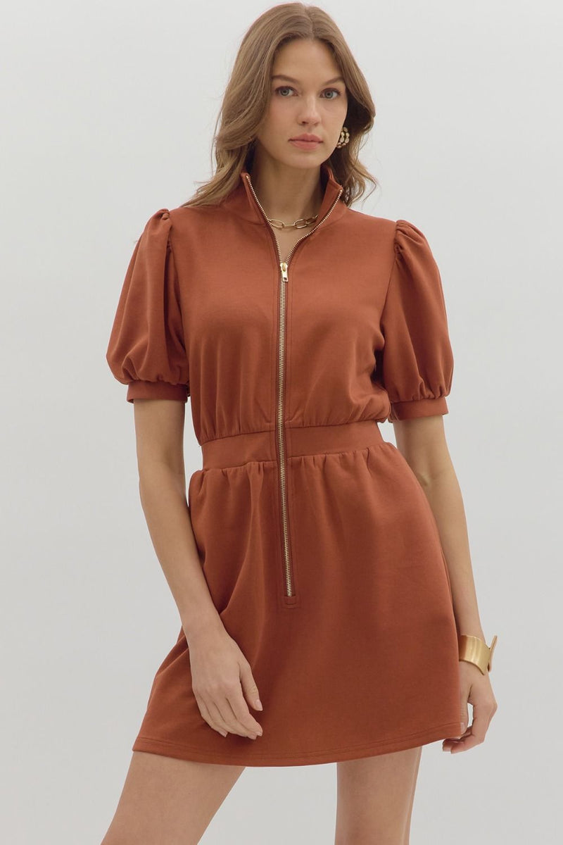 Woman wearing a brown dress with puff sleeves modern classic 