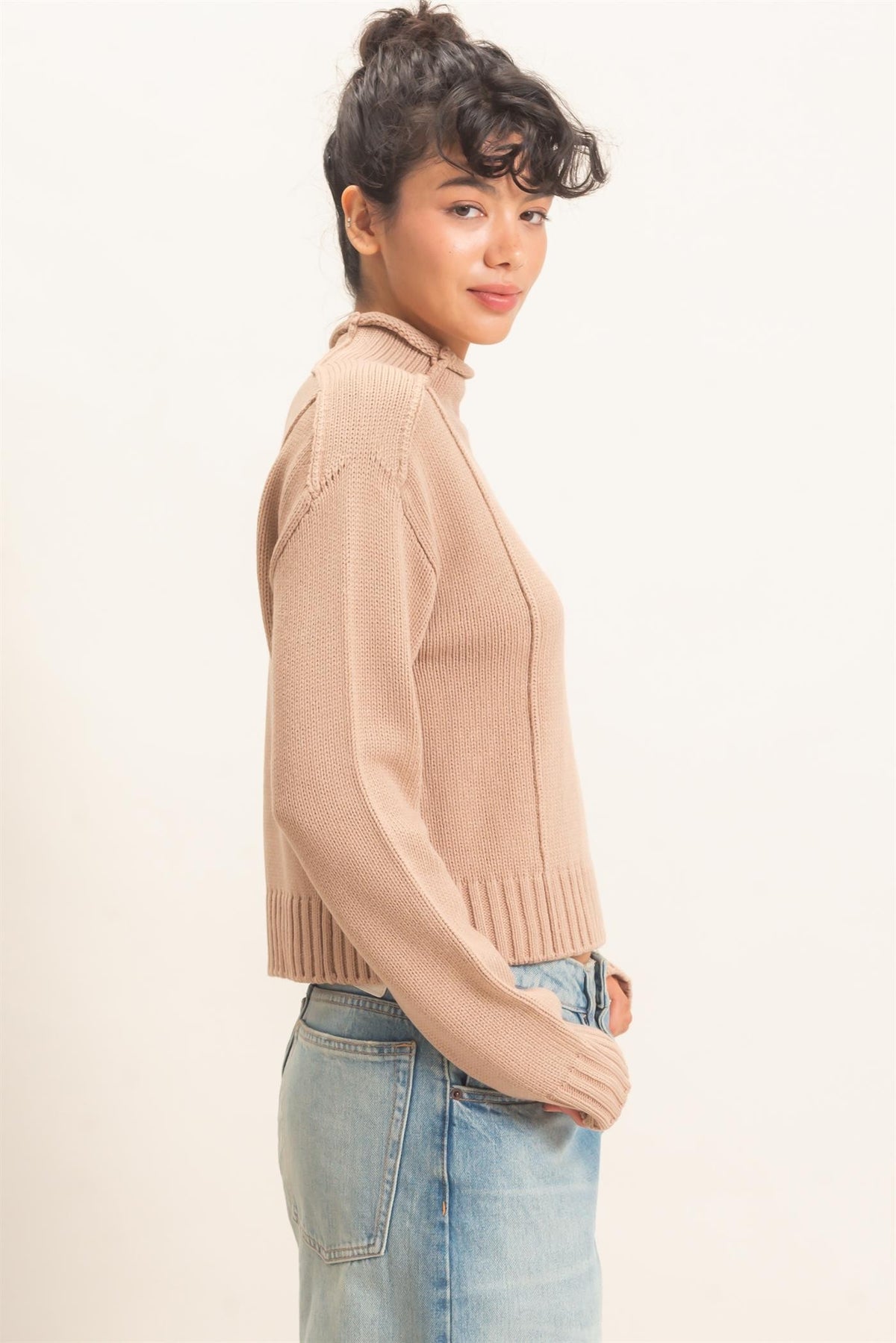 Remy Roll Neck Reversed Seam Sweater in Taupe — back view on model showing reversed seam detailing